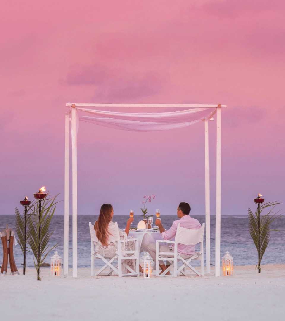 Luxury destination dining table set up on the beach at Vakkaru Maldives